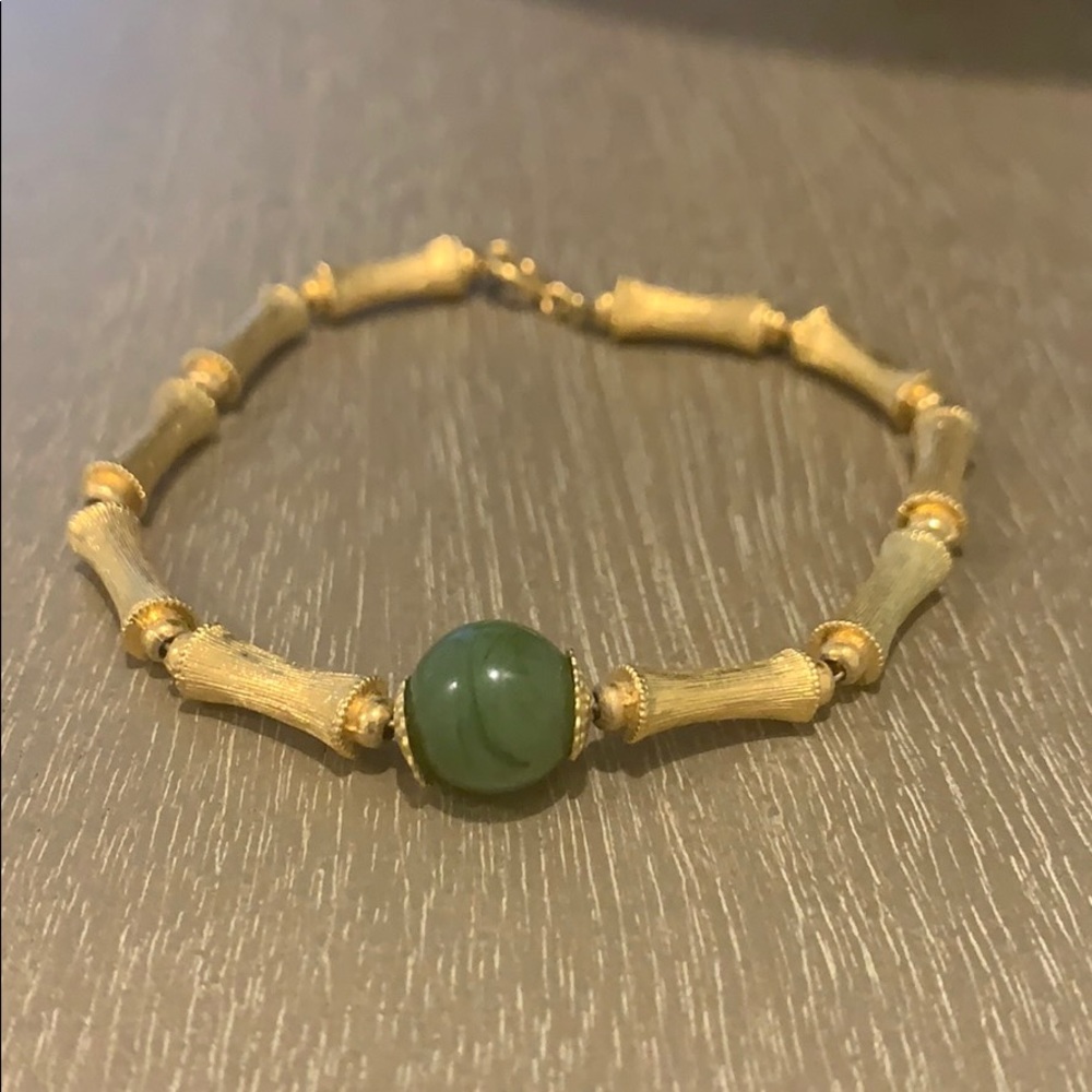 Simple gold bracelet with green stone